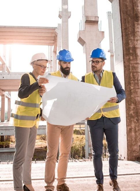 Three architecturers are discussing about a structure of building and one logo pasban builders